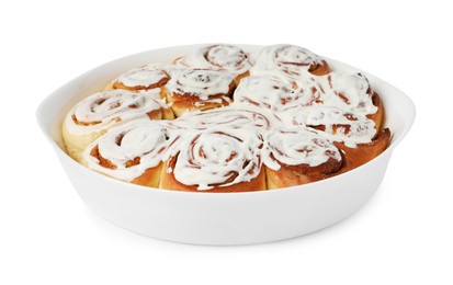 Photo of Delicious frosted cinnamon rolls in baking dish isolated on white