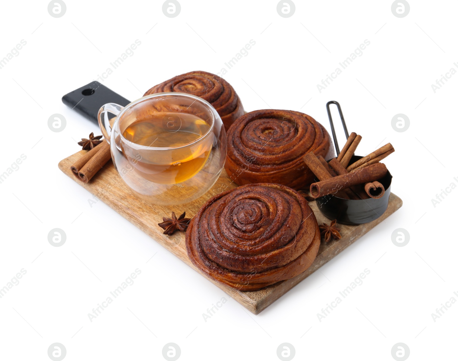 Photo of Delicious cinnamon roll buns with tea and spices isolated on white