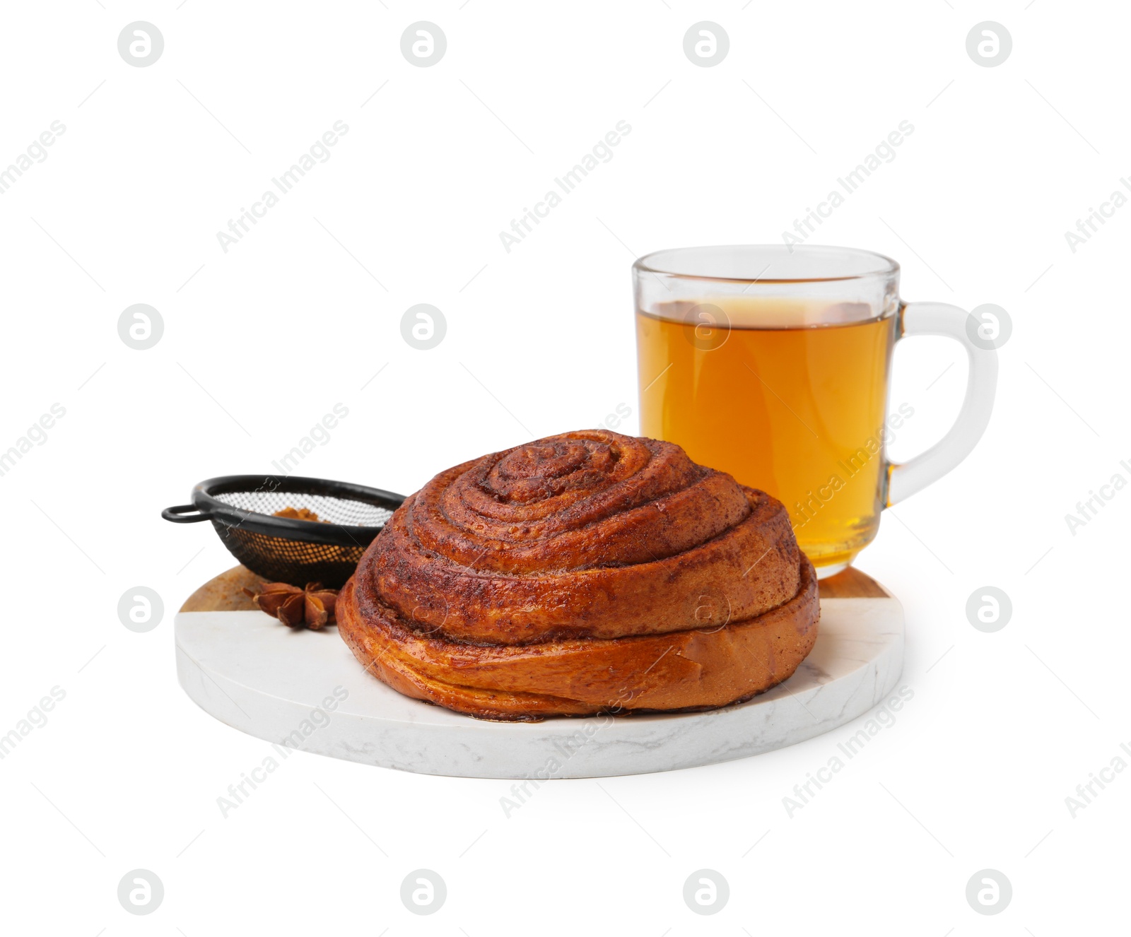 Photo of Delicious cinnamon roll bun, tea and spices isolated on white