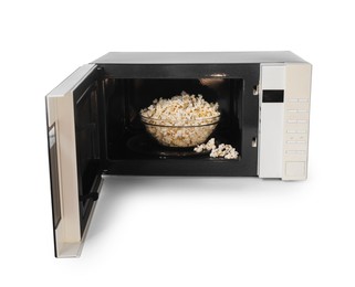 Photo of Open microwave oven with bowl of popcorn isolated on white