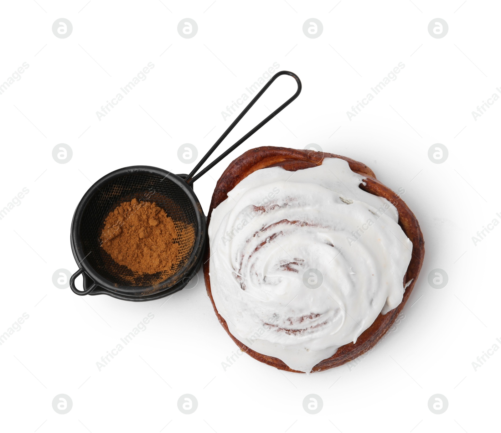 Photo of Tasty roll with cream and cinnamon isolated on white, top view