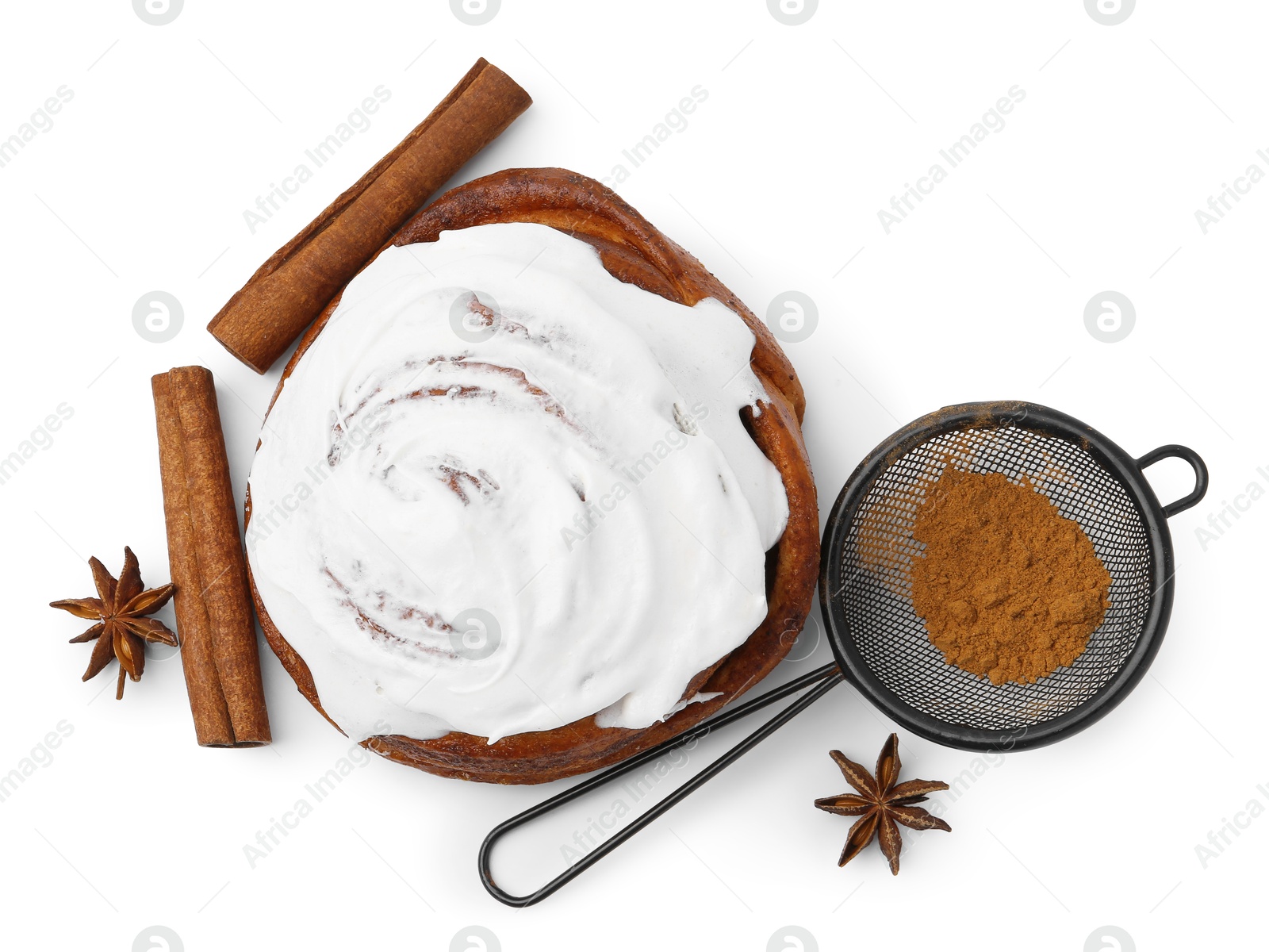 Photo of Tasty cinnamon roll with cream and spices isolated on white, top view