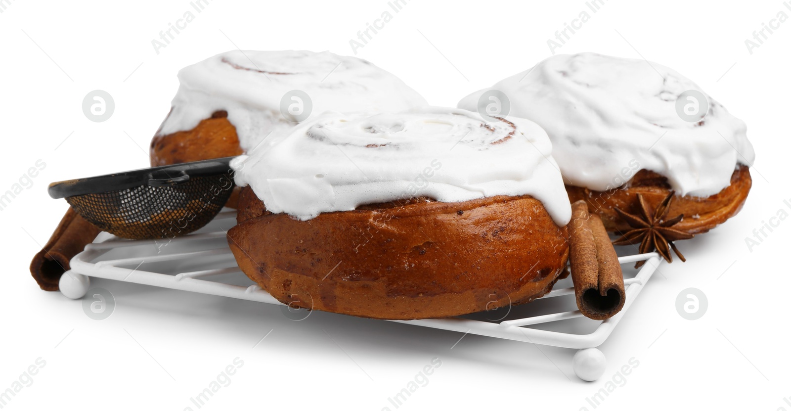 Photo of Tasty cinnamon rolls with cream and spices isolated on white