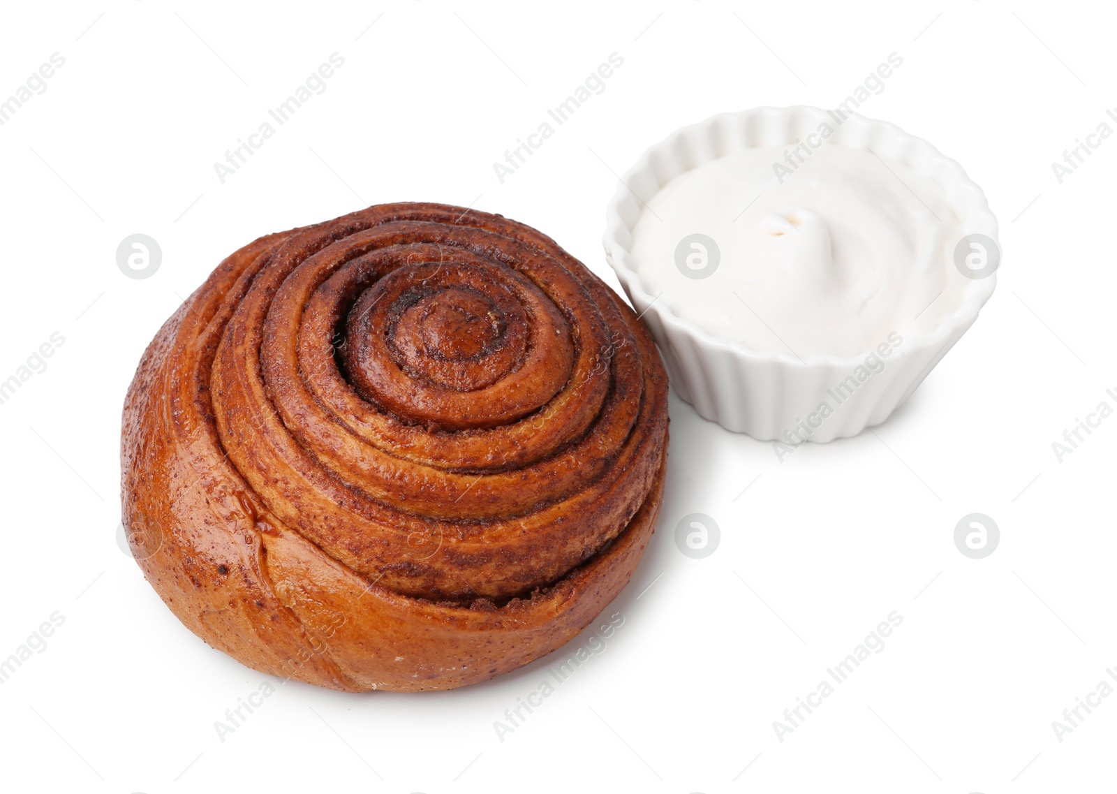 Photo of Tasty cinnamon roll with cream isolated on white