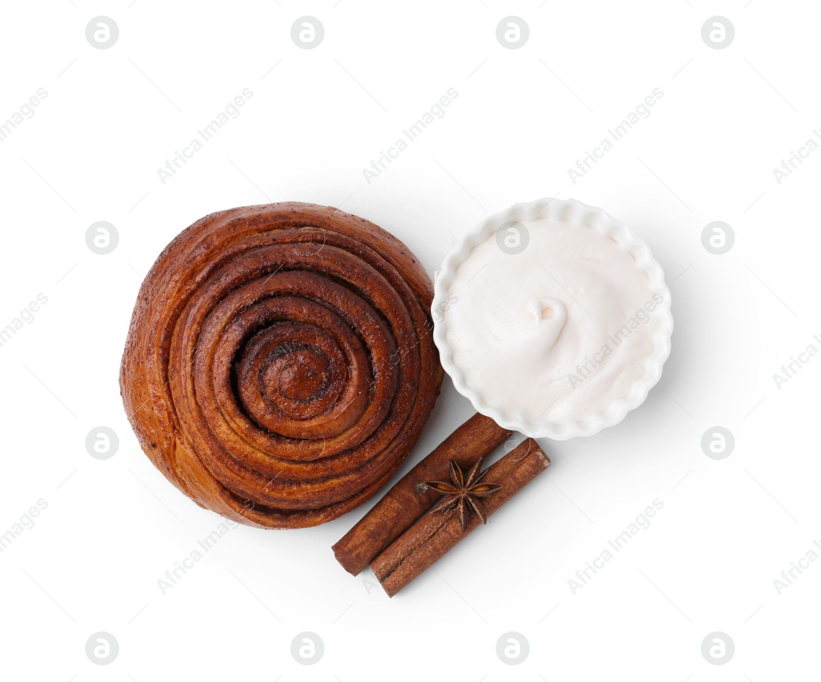 Photo of Tasty cinnamon roll with cream and sticks isolated on white, top view