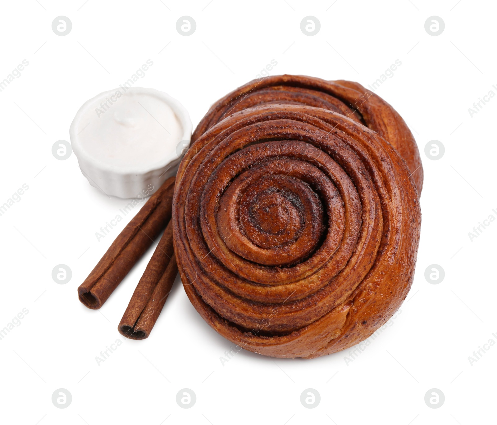 Photo of Tasty cinnamon rolls with cream and sticks isolated on white