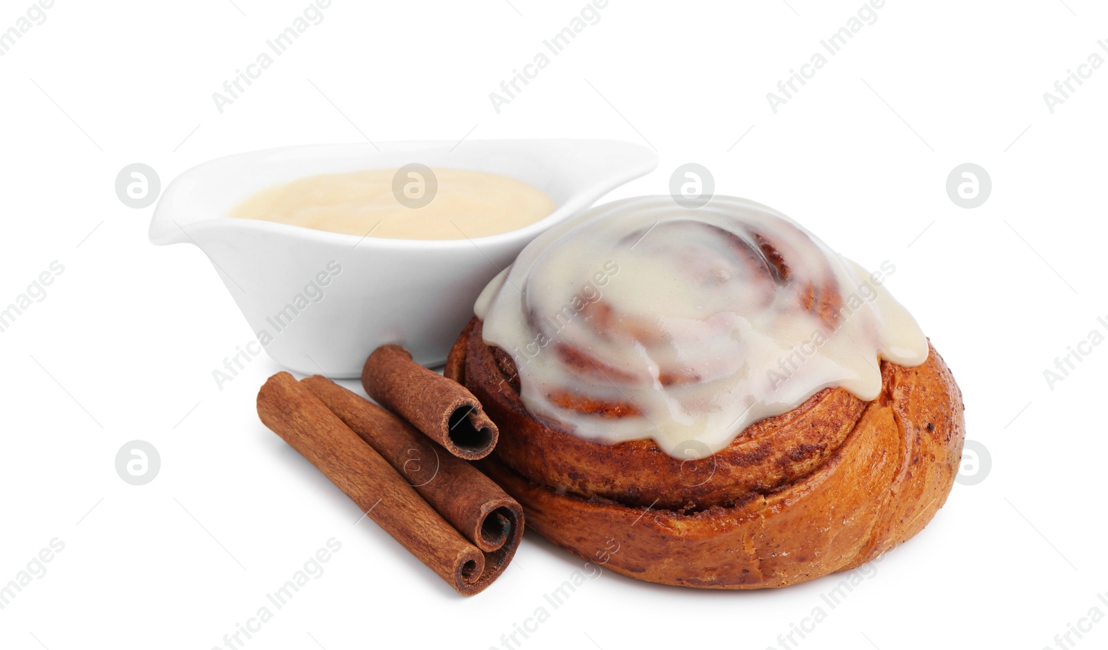 Photo of Tasty cinnamon roll with cream and spices isolated on white