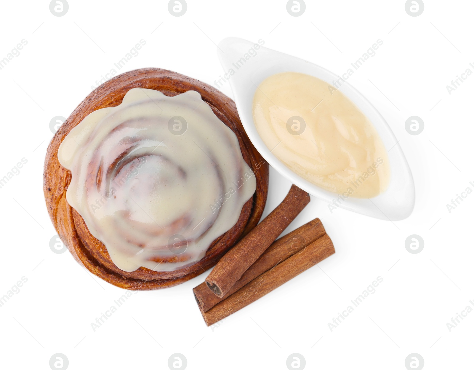 Photo of Tasty cinnamon roll with cream and spices isolated on white, top view