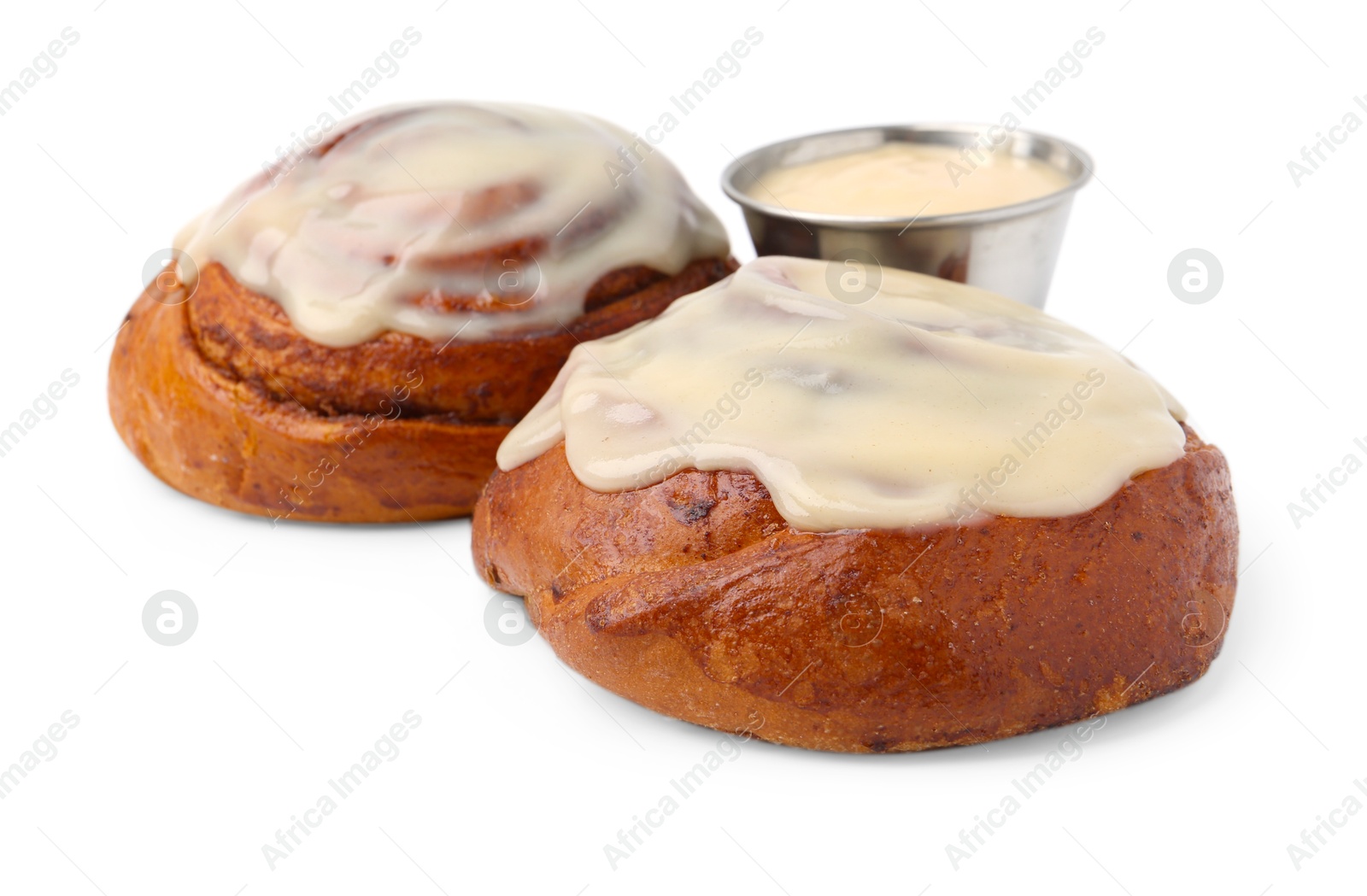 Photo of Tasty cinnamon rolls with cream isolated on white