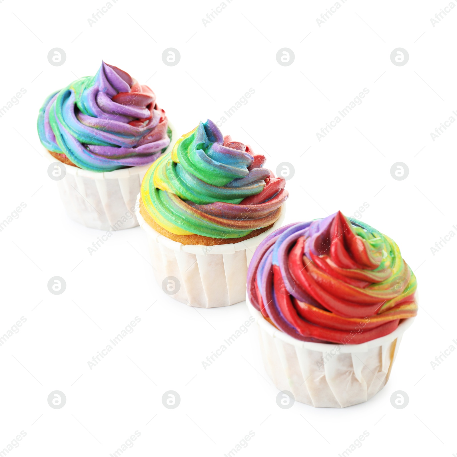 Photo of Delicious cupcakes with colorful cream isolated on white