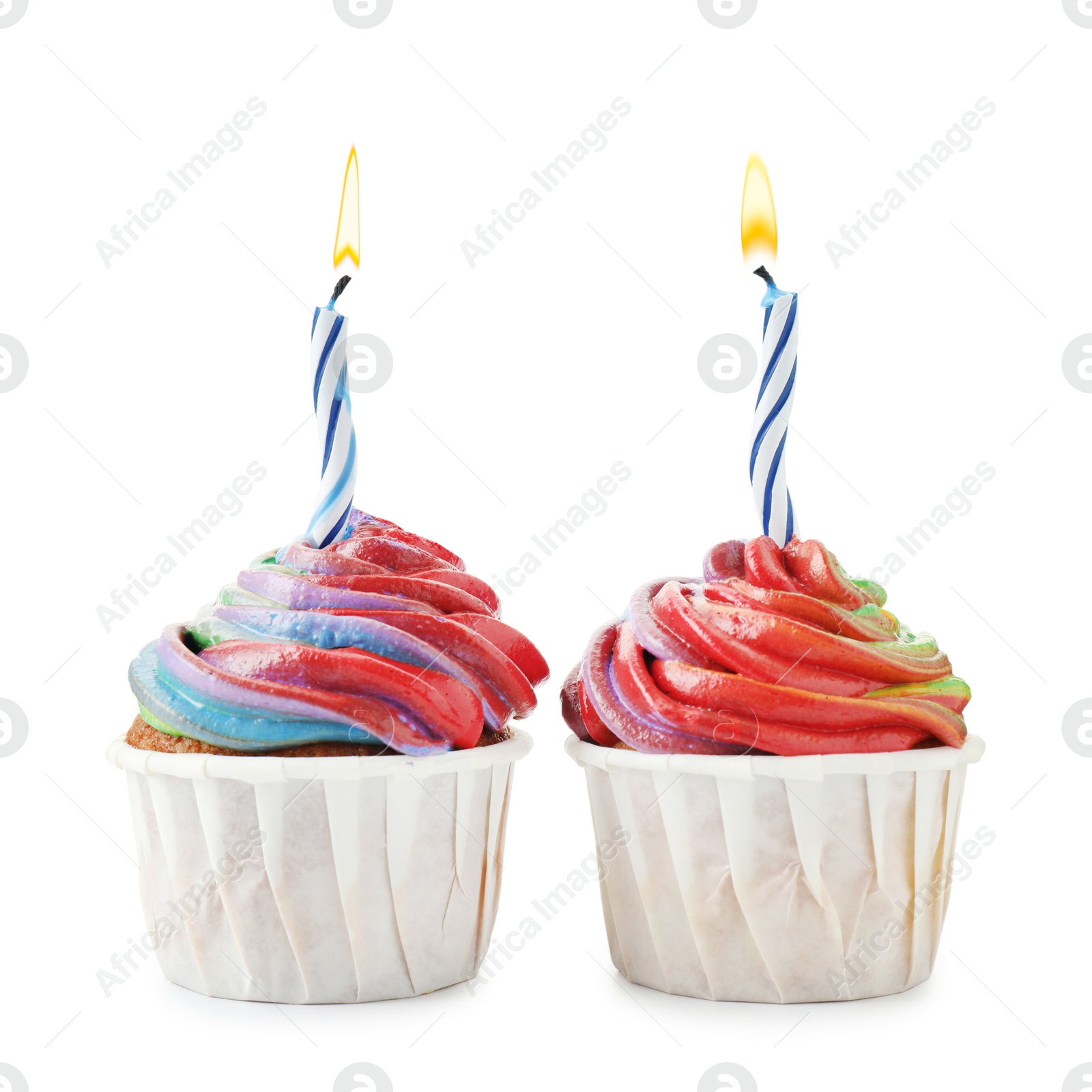 Photo of Delicious cupcakes with colorful cream and candles isolated on white