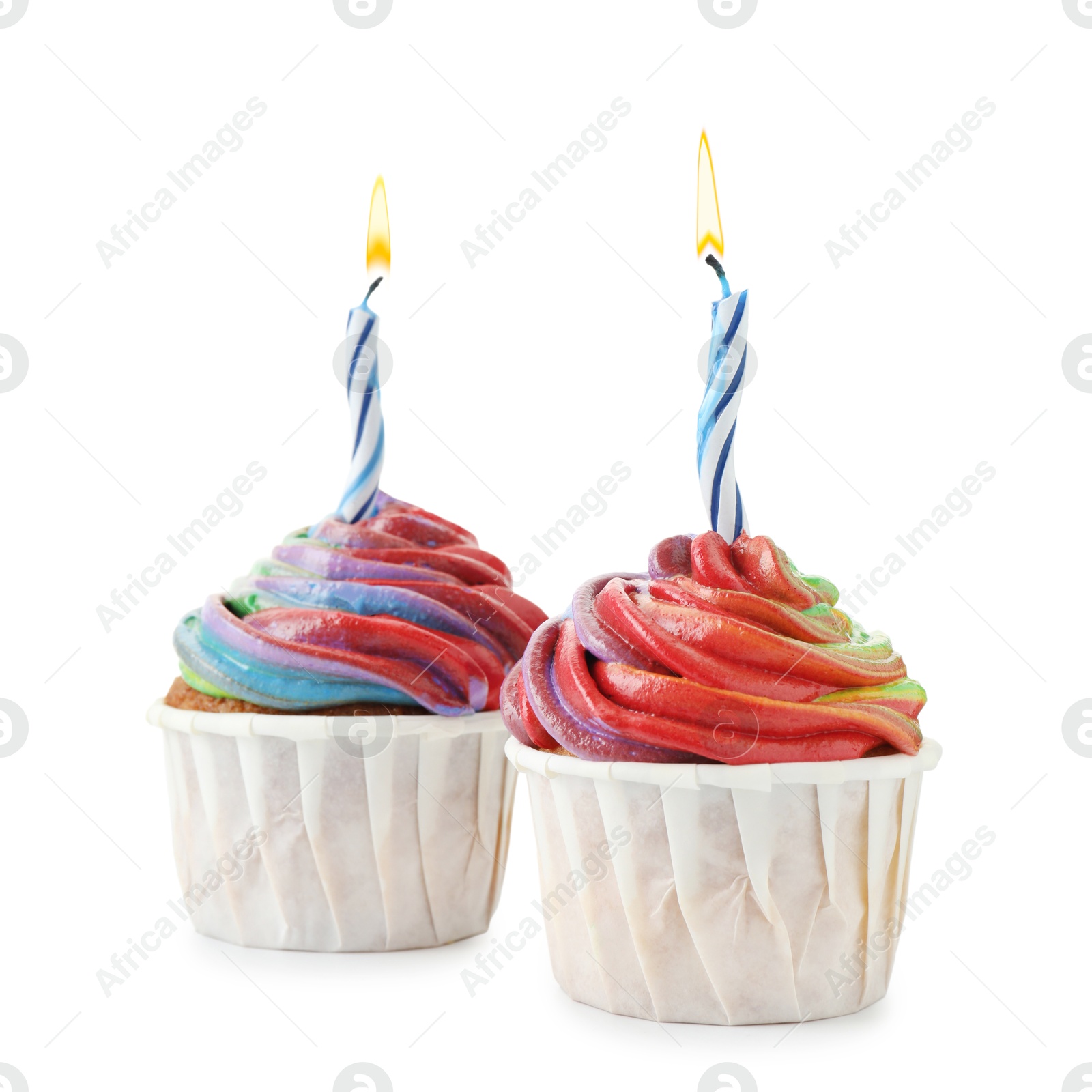 Photo of Delicious cupcakes with colorful cream and candles isolated on white