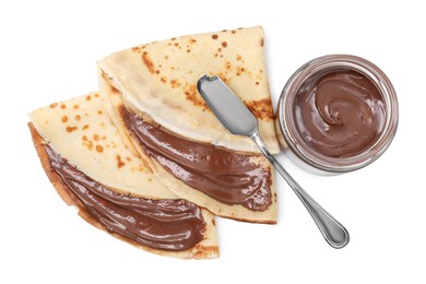 Photo of Tasty crepes with chocolate butter and knife isolated on white, top view