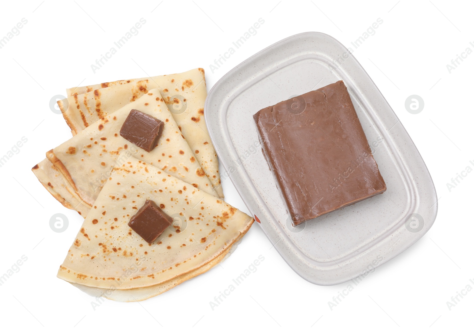 Photo of Tasty crepes with chocolate butter isolated on white, top view