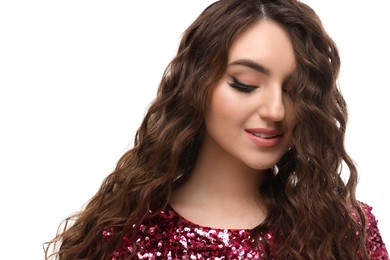 Photo of Beautiful young woman with long curly brown hair in pink sequin dress on white background