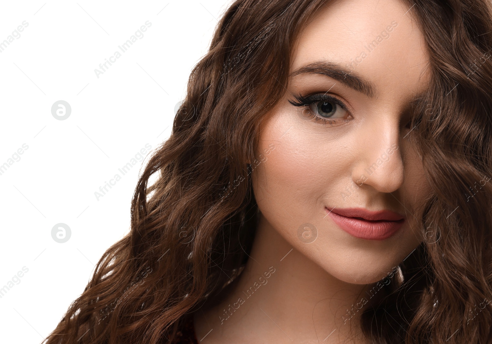 Photo of Beautiful young woman with long curly brown hair on white background, closeup