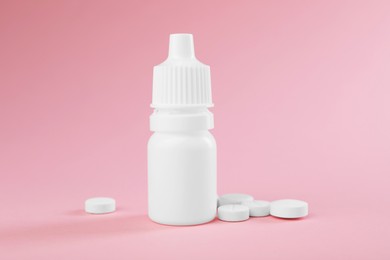 Photo of Allergy treatment. Nasal drops and pills on pink background, closeup