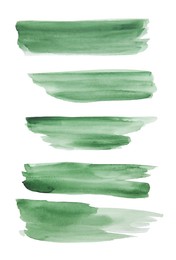 Photo of Green watercolor strokes on white background, top view