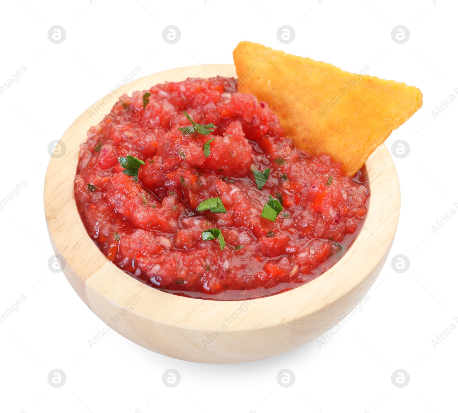 Photo of Spicy salsa sauce in bowl and nacho chip isolated on white