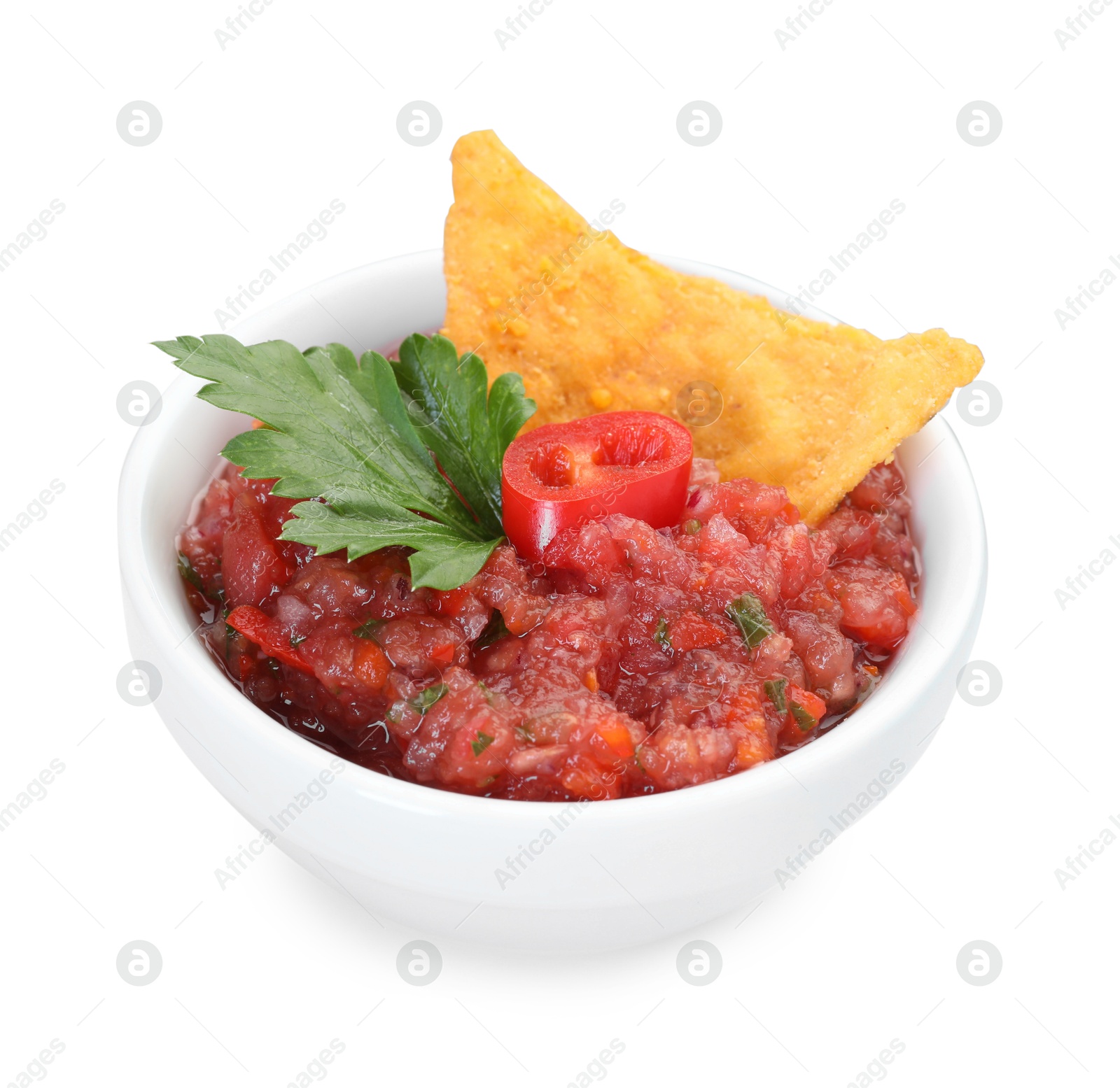 Photo of Spicy salsa sauce in bowl and nacho chip isolated on white