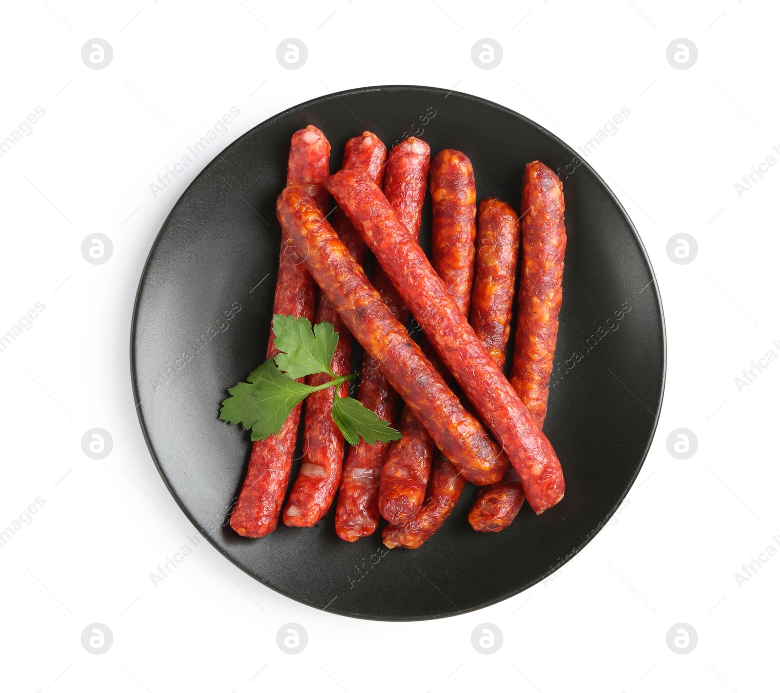 Photo of Many thin dry cured sausages with parsley isolated on white, top view