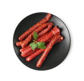 Photo of Many thin dry cured sausages with parsley isolated on white, top view