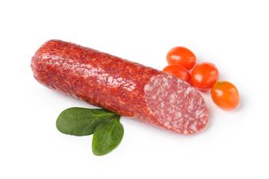 Photo of Piece of delicious smoked sausage with basil and tomatoes isolated on white