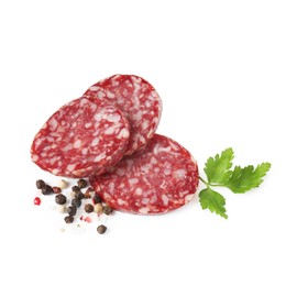 Photo of Pieces of delicious dry cured sausage and spices isolated on white, top view