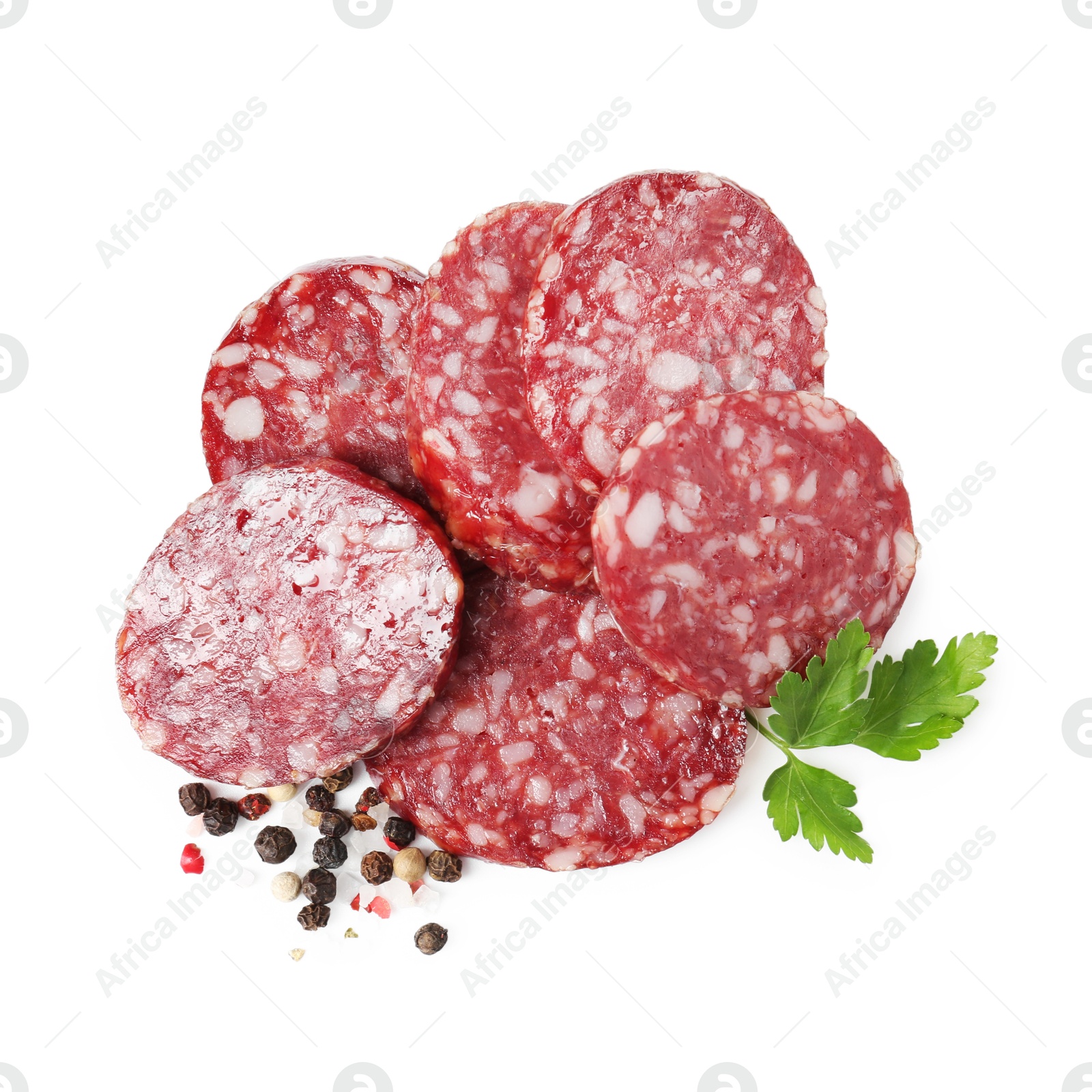 Photo of Pieces of delicious dry cured sausage and spices isolated on white, top view