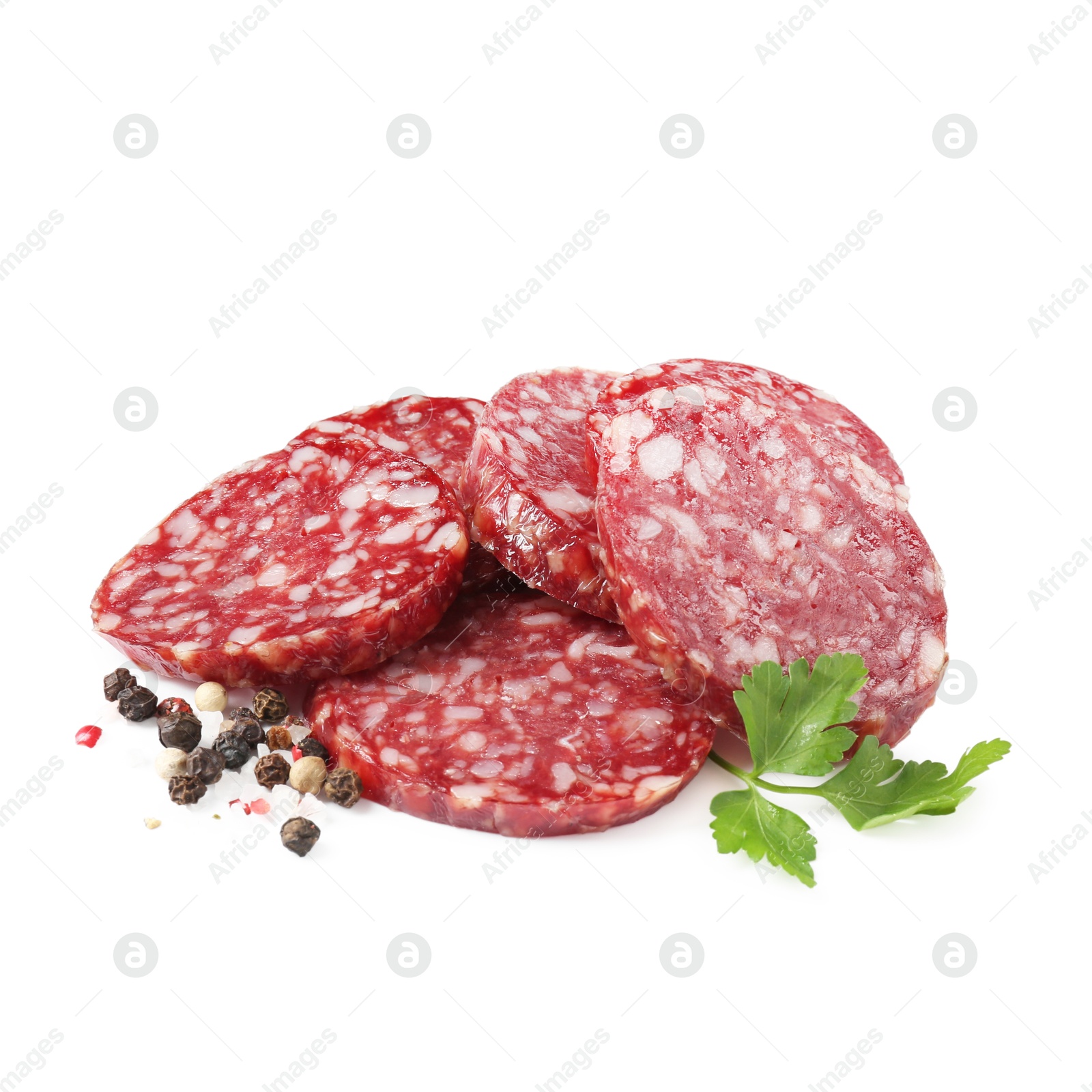 Photo of Pieces of delicious dry cured sausage and spices isolated on white