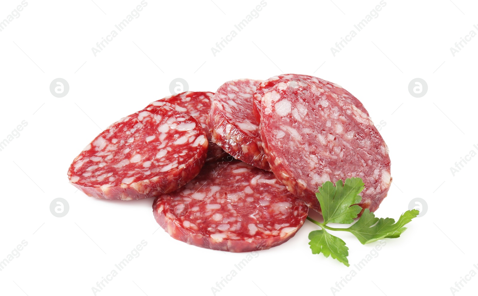 Photo of Pieces of delicious dry cured sausage and parsley isolated on white