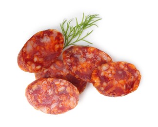 Photo of Pieces of delicious dry cured sausage and dill isolated on white, top view