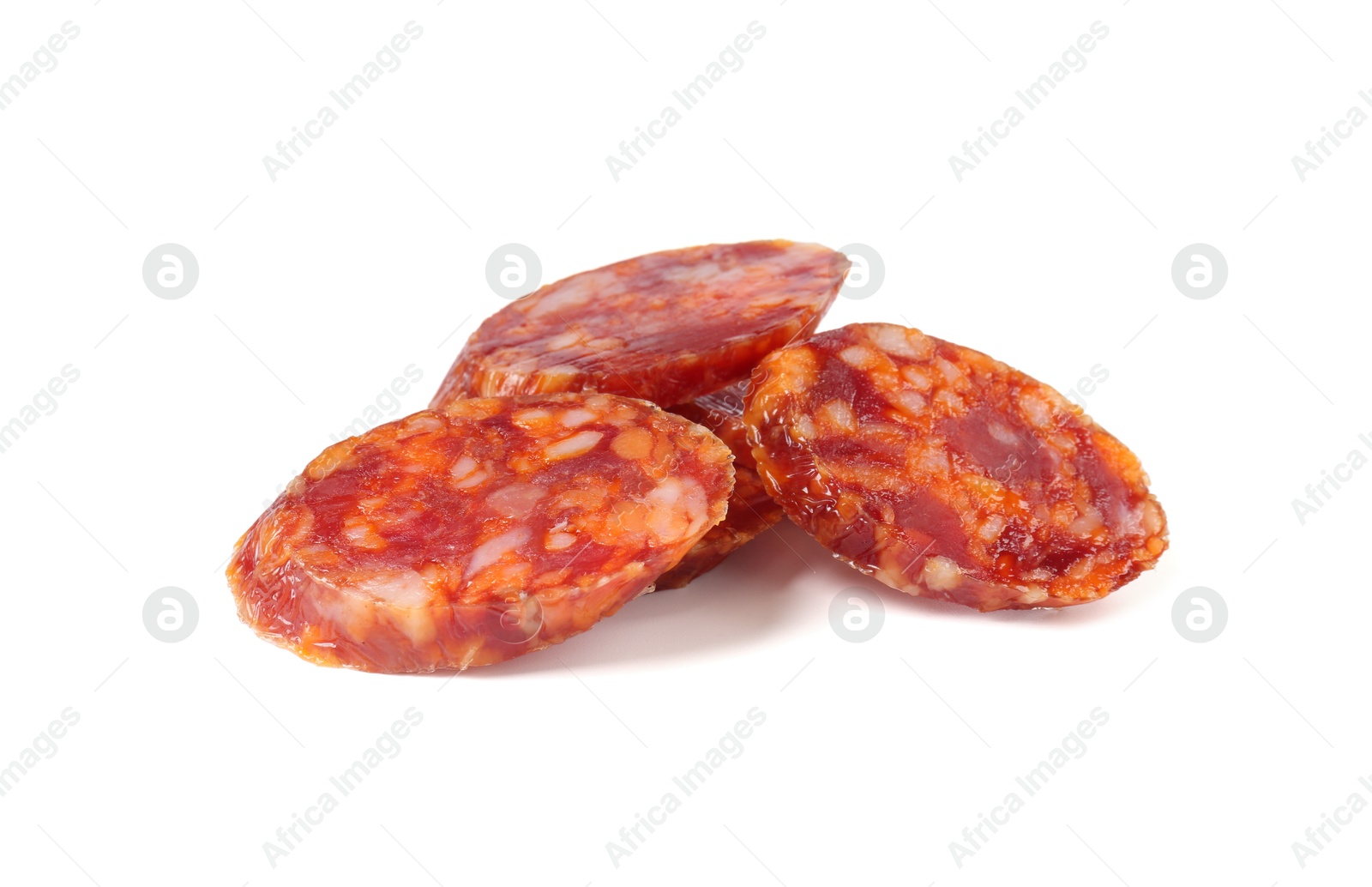 Photo of Pieces of delicious dry cured sausage isolated on white