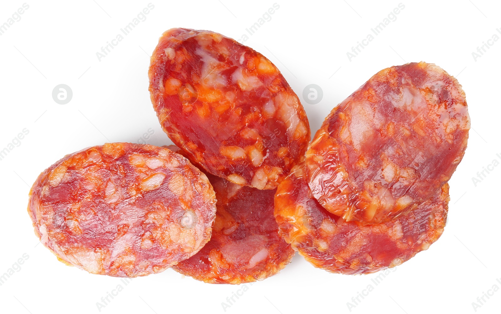 Photo of Pieces of delicious dry cured sausage isolated on white, top view