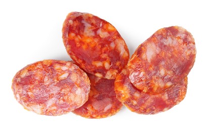 Photo of Pieces of delicious dry cured sausage isolated on white, top view