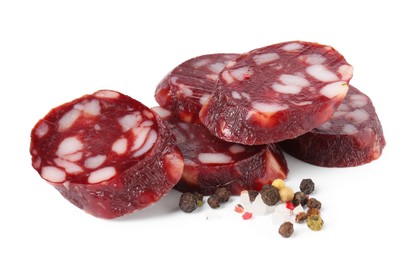 Photo of Pieces of delicious dry cured sausage and spices isolated on white