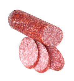 Photo of Pieces of delicious smoked sausage isolated on white, top view