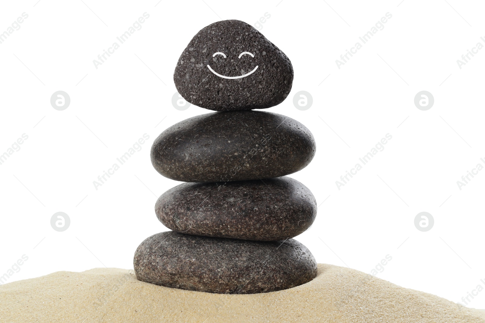 Photo of Stack of stones with drawn smiley face on sand against white background. Harmony and life balance