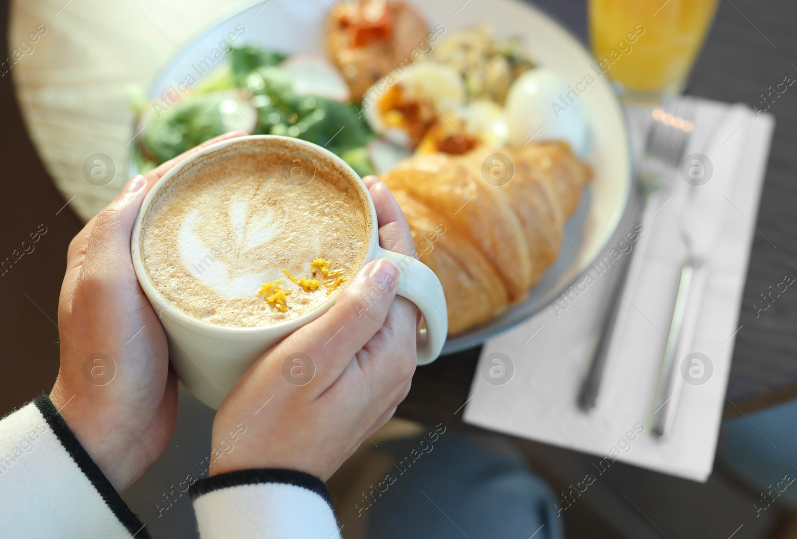 Photo of Woman having tasty breakfast in cafe, closeup