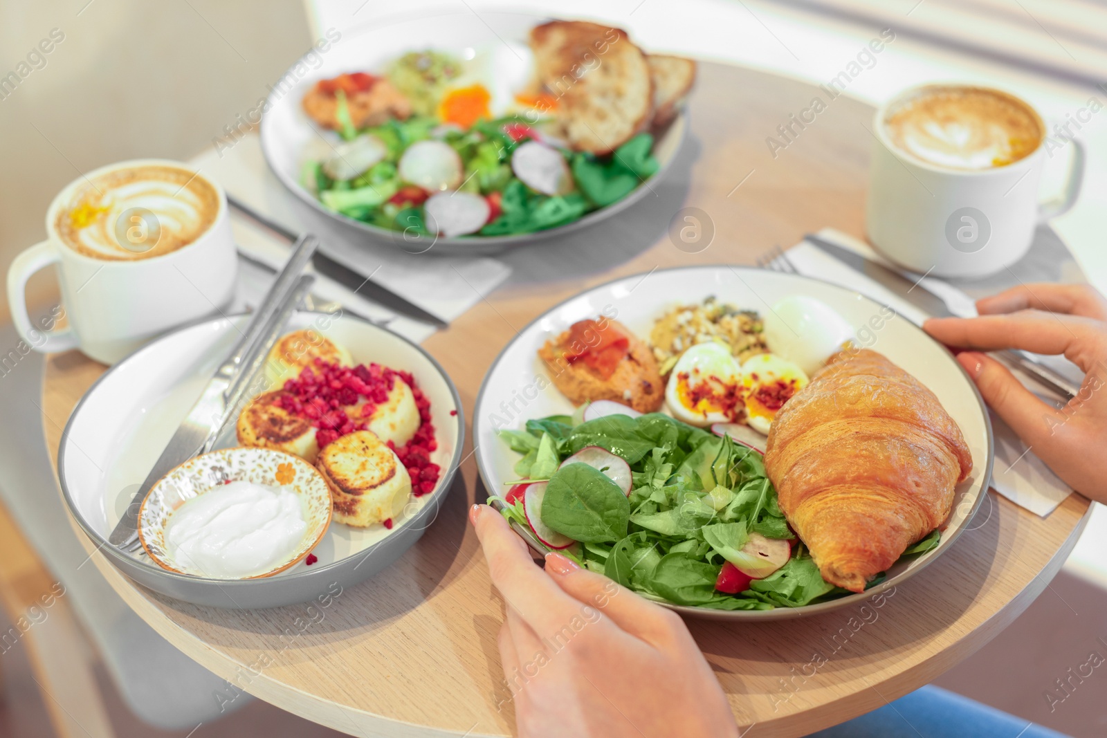 Photo of Woman having tasty breakfast in cafe, closeup