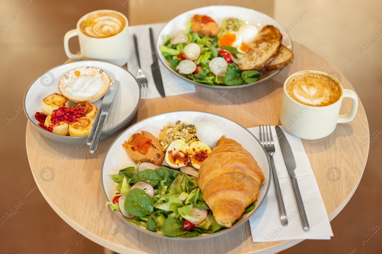 Photo of Tasty breakfast. Different meals and coffee served on wooden table in cafe