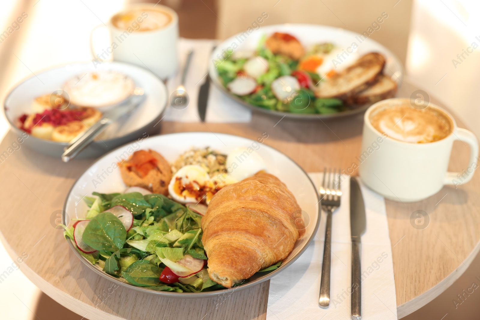 Photo of Tasty breakfast. Different meals and coffee served on wooden table in cafe, closeup