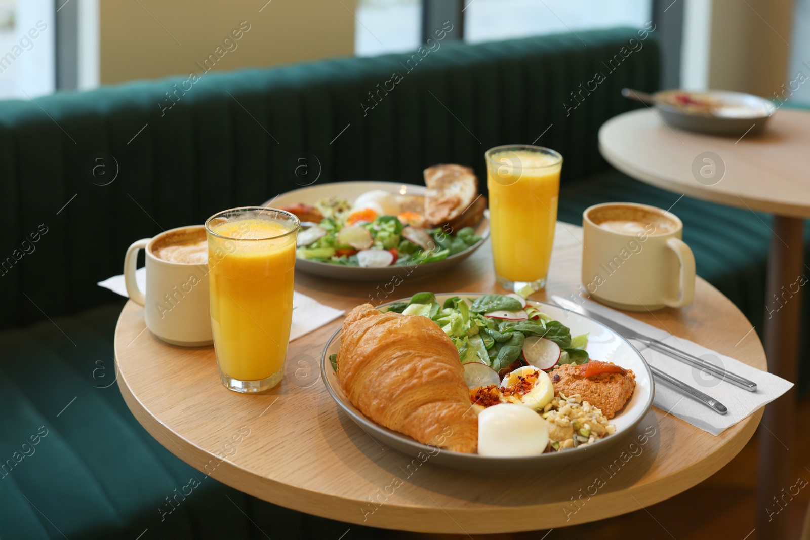 Photo of Tasty breakfast. Different meals and drinks served on wooden table in cafe