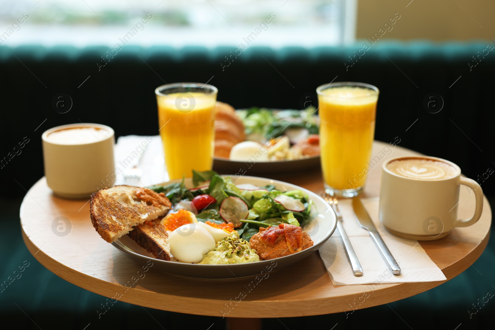 Photo of Tasty breakfast. Different meals and drinks served on wooden table in cafe