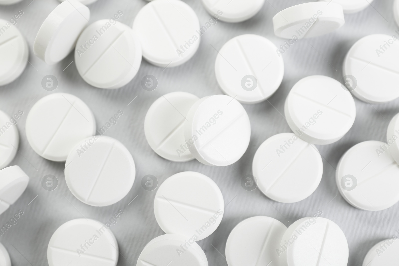 Photo of Many antibiotic pills on grey background, closeup