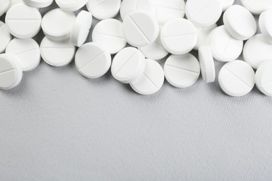 Photo of Many antibiotic pills on grey background, above view. Space for text