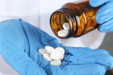 Photo of Doctor with bottle of antibiotic pills, closeup