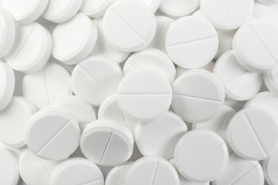 Photo of Pile of antibiotic pills on white background, closeup