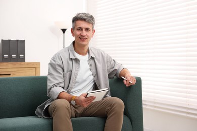 Photo of Portrait of professional psychologist with notebook in office