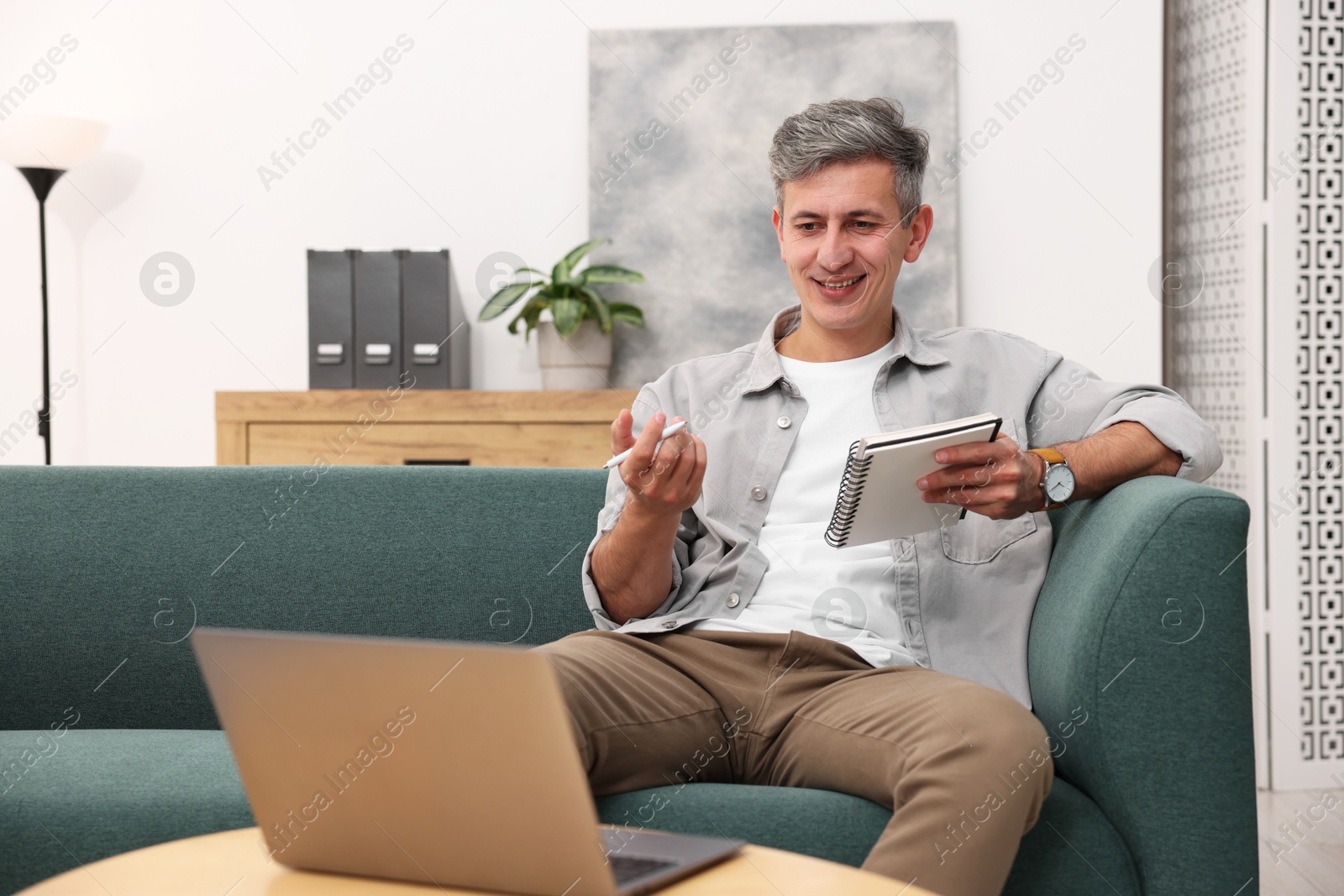 Photo of Professional psychologist working with laptop and notebook in office